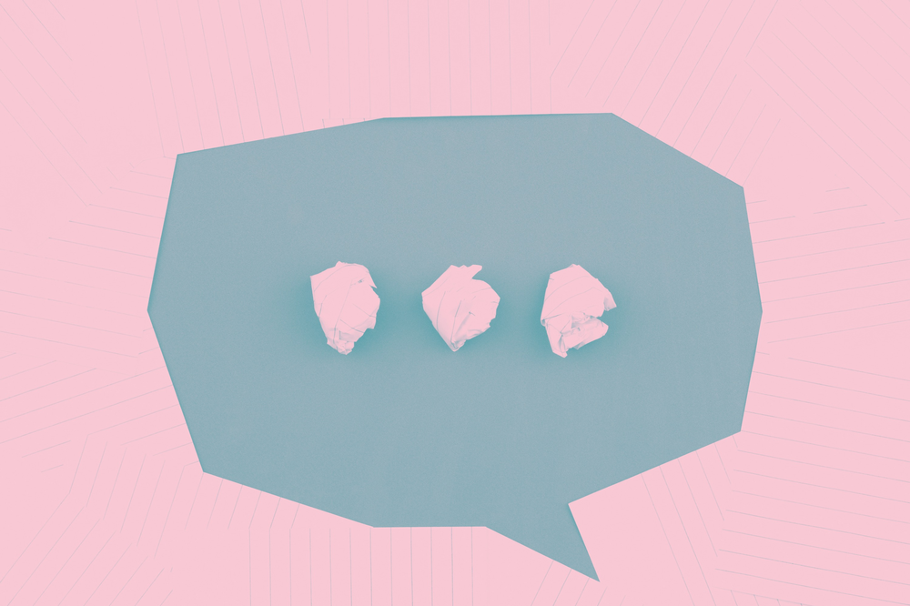 a blue speech bubble on a pink background