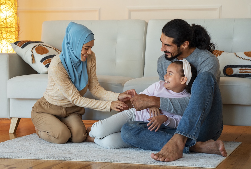 Happy Islamic family sitting on the floor